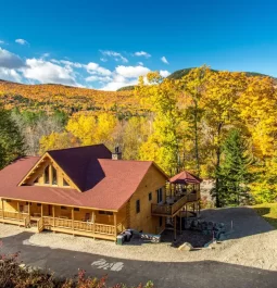 log cabin surrounded by fall foliage