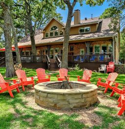 fire pit surrounded by adirondack chairs