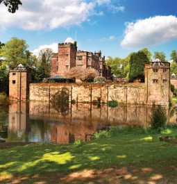 Colourful stone castle with lake in front