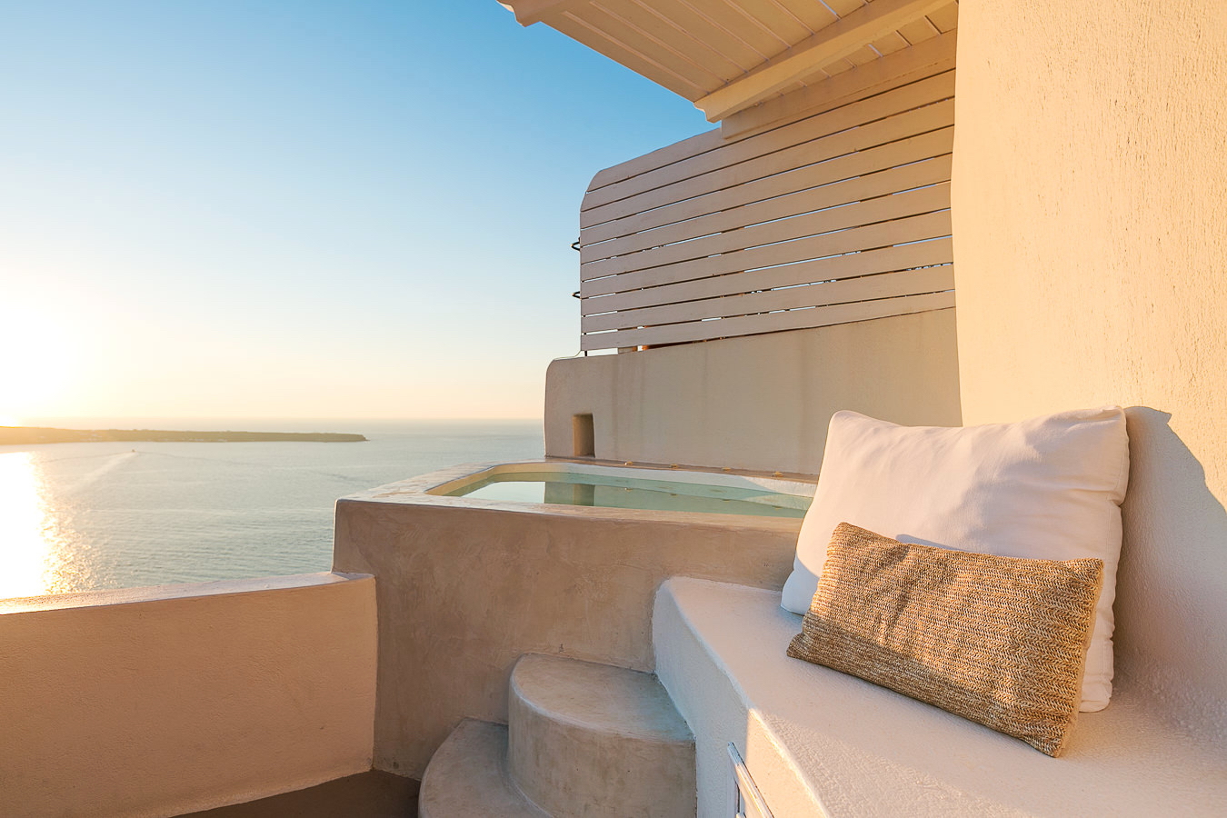 Sandstone edge of cave with jacuzzi overlooking sea