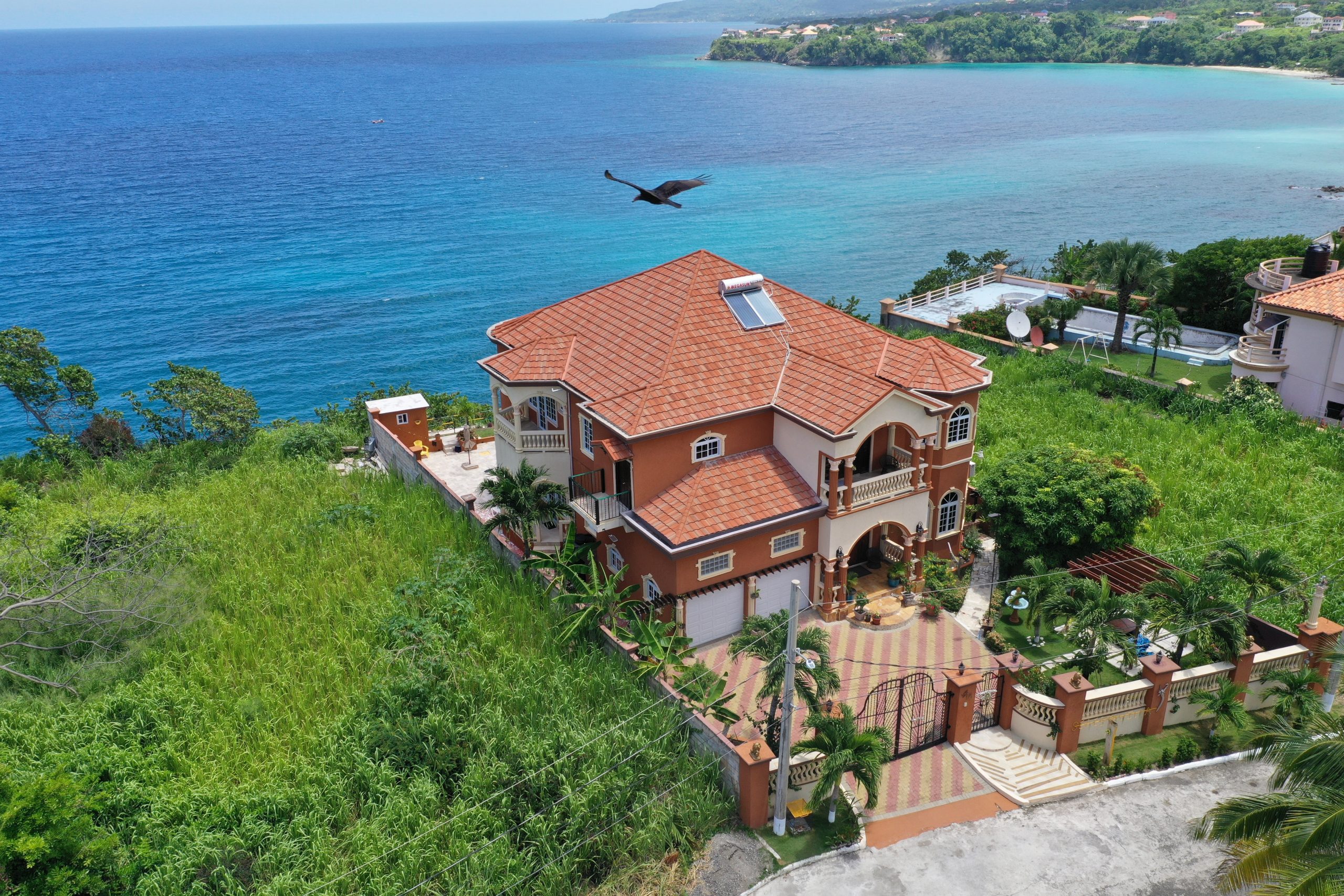 Bird's eye view of terracotta villa by the sea