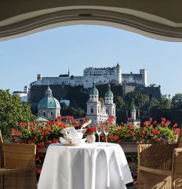 Dining table on a terrace overlooking Salzburg Fortress