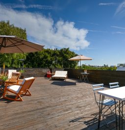 Wooden rooftop with table and blue skies