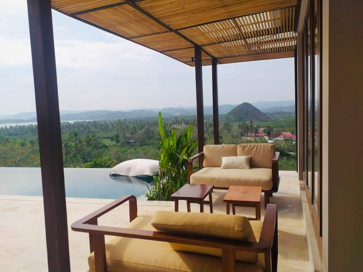 Infinity pool next to outdoor terrace