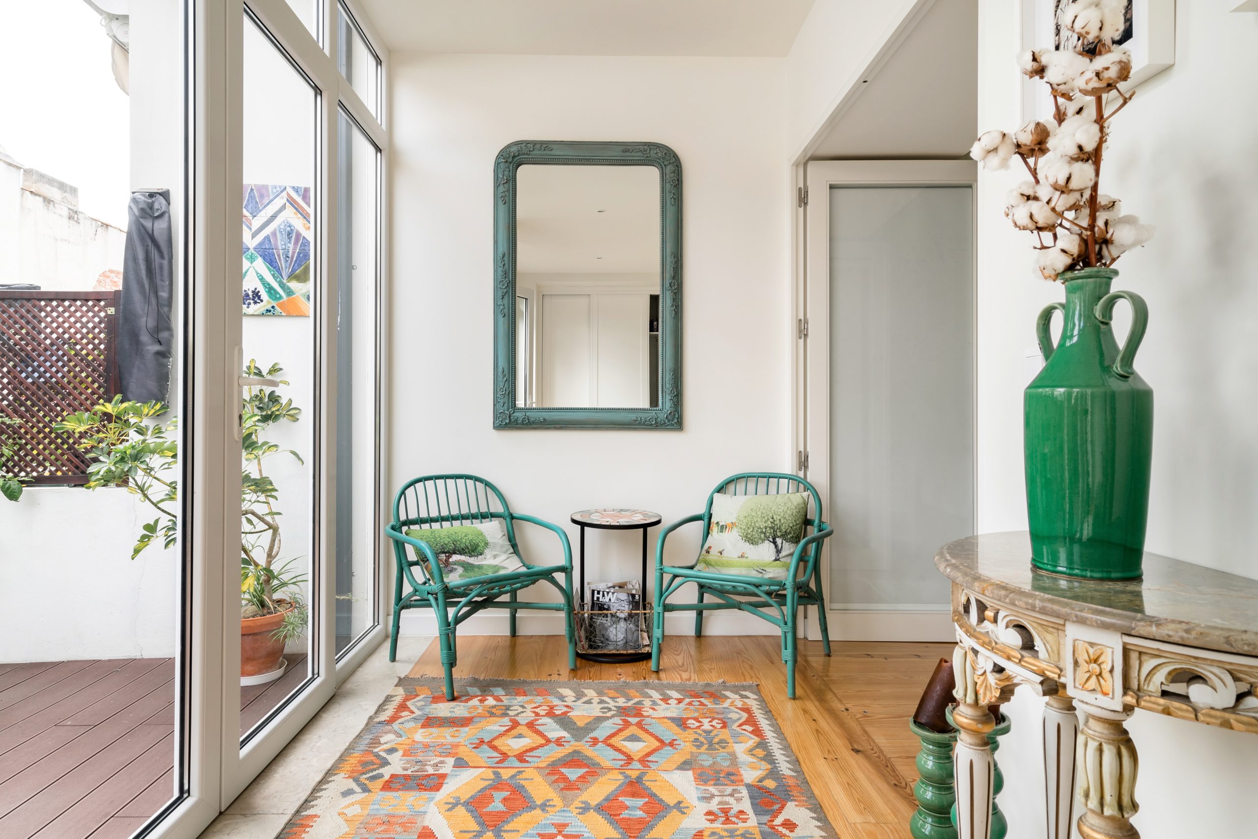 White and green accented hallway next to the balcony