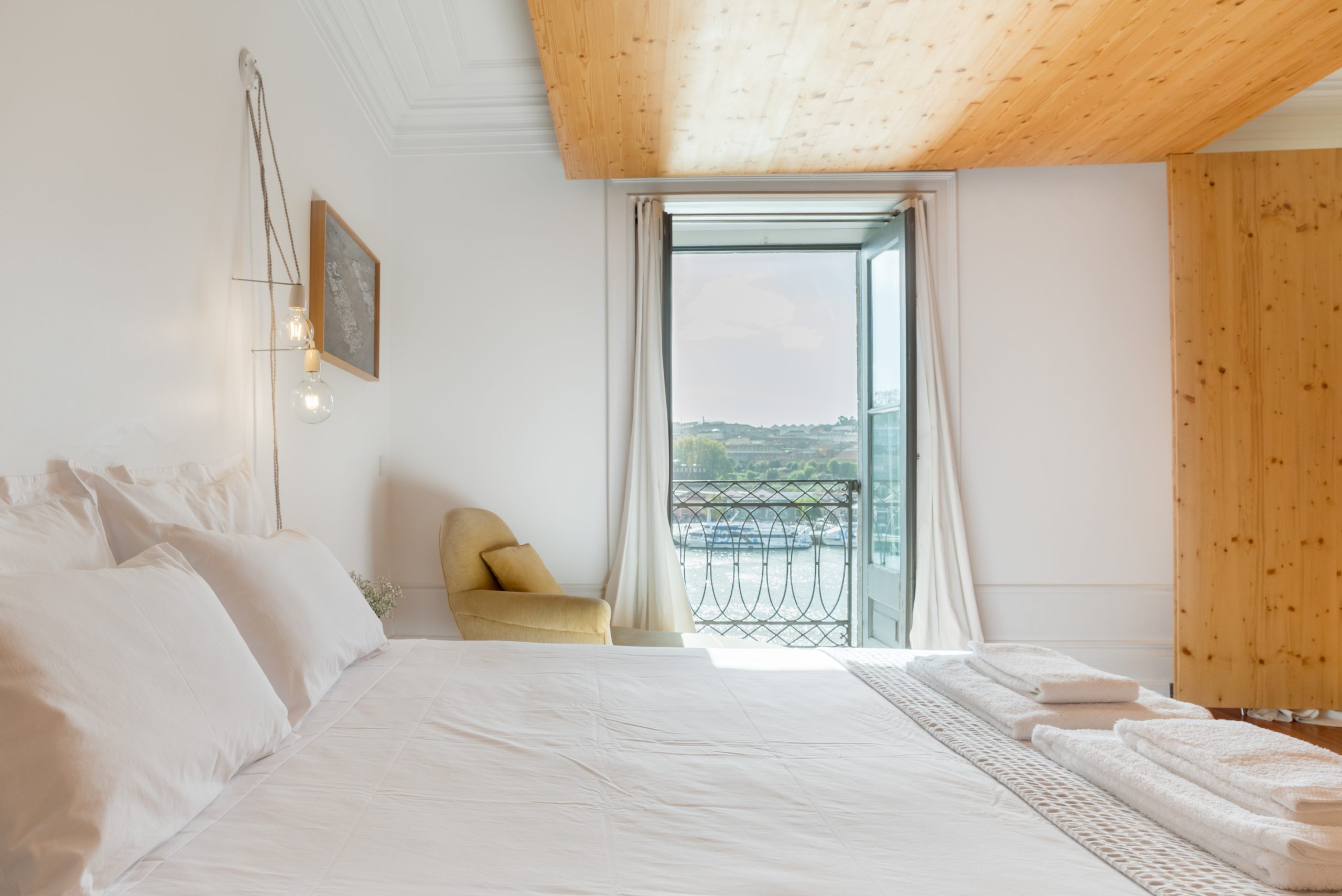 Airy white bedroom with balcony 