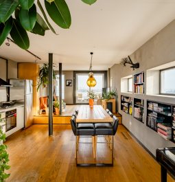 Bright open-space apartment with a dining table and a kitchen corner