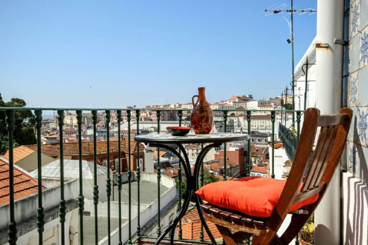 Red chairs on the terrace overlooking the city