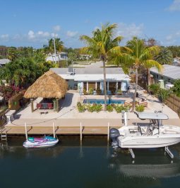 Aerial view of home, dock, and boats