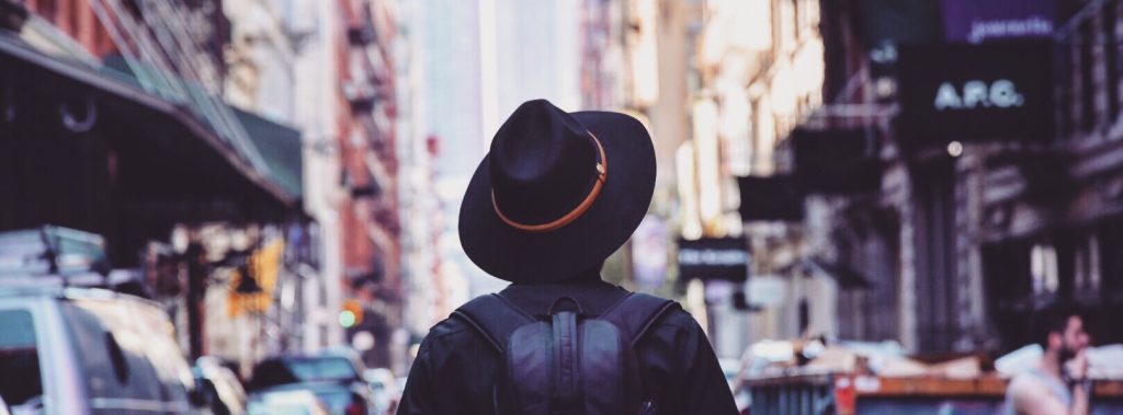 Person in Hat Walking Down New York City Street