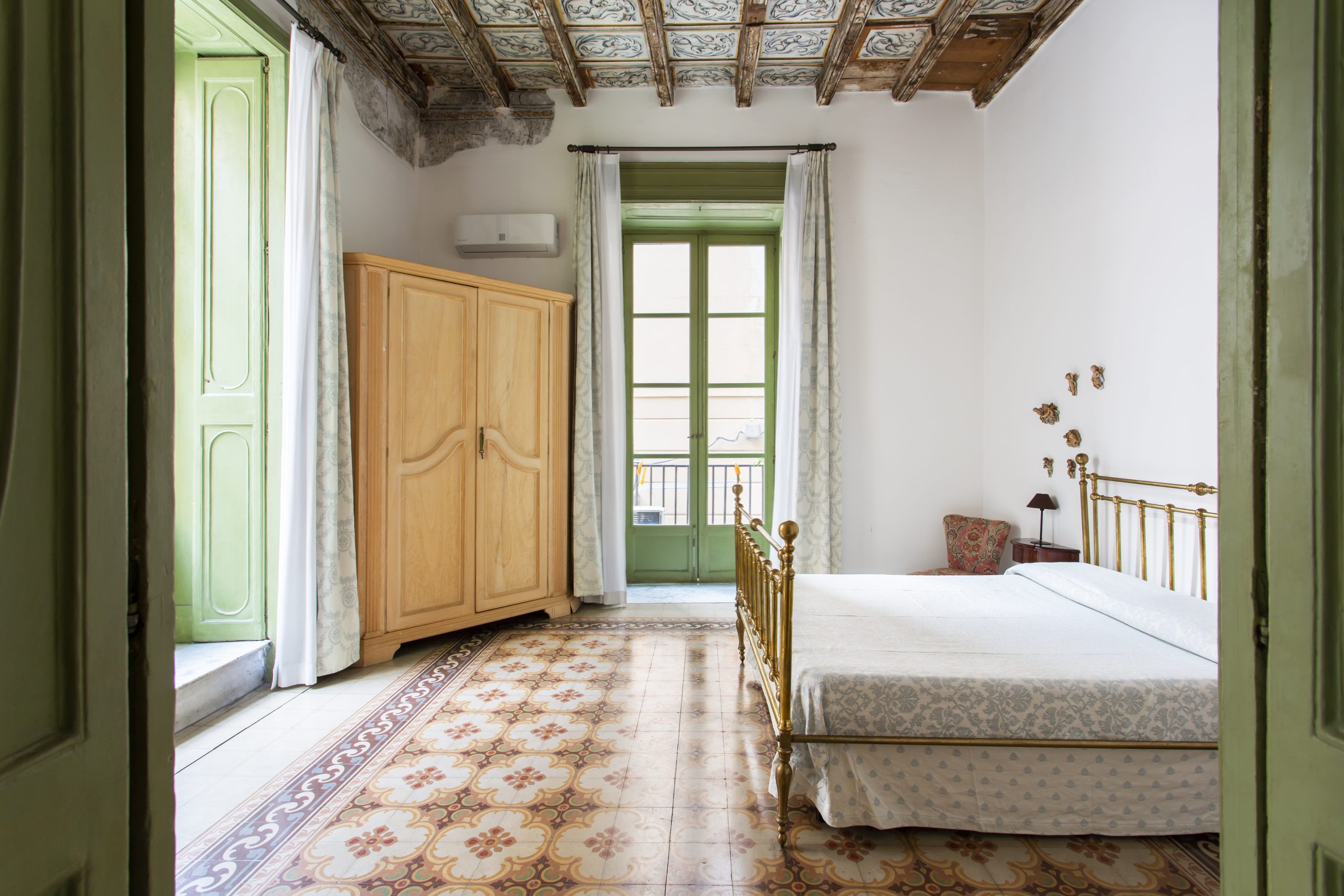 The bedroom furnished with antique family furniture