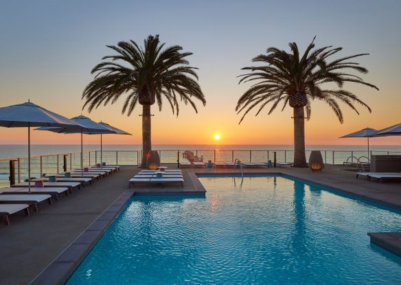 pool with a sunset and ocean view