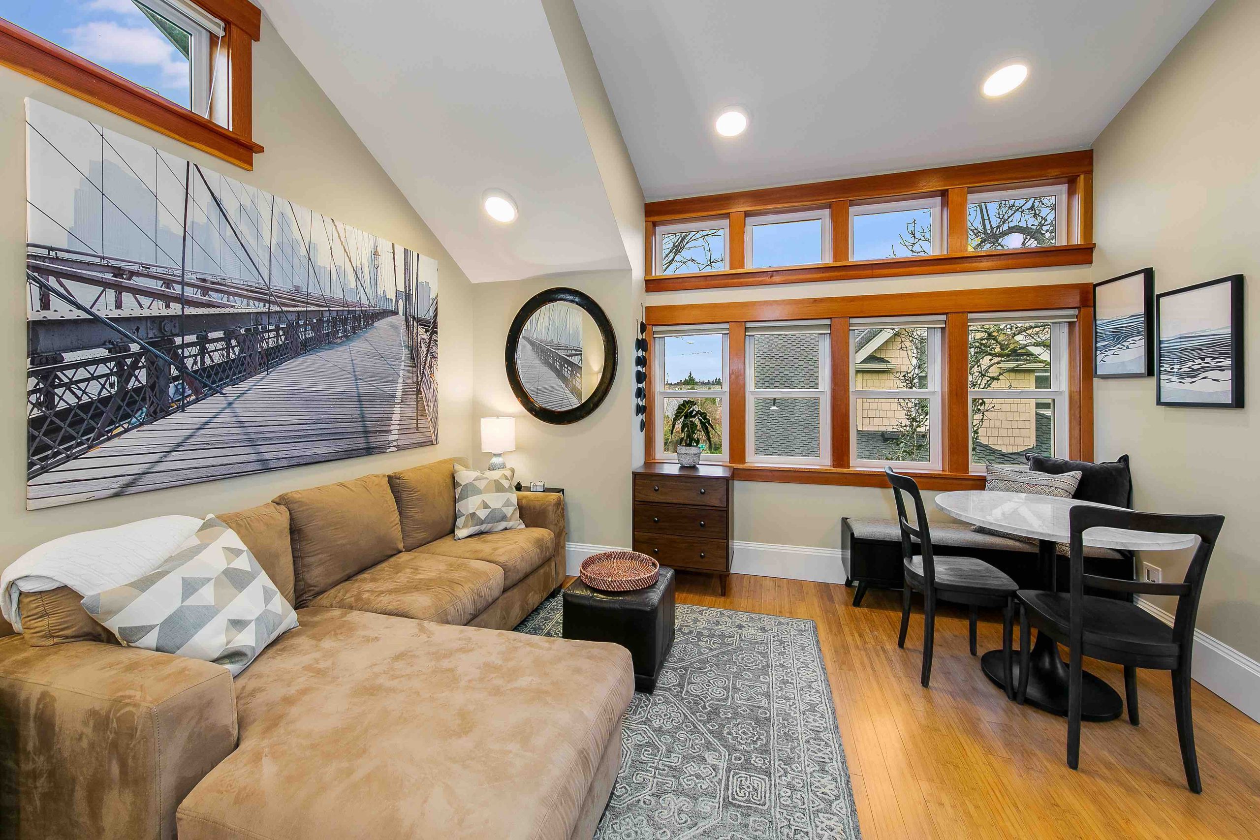 Cozy living room with large windows and L-shaped sofa