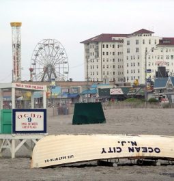 kayak and lifeguard stand on beach with hotel behind