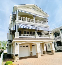 Multi-story beach house exterior with garage underneath