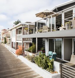 Front view of beachfront apartment with boardwalk and plants