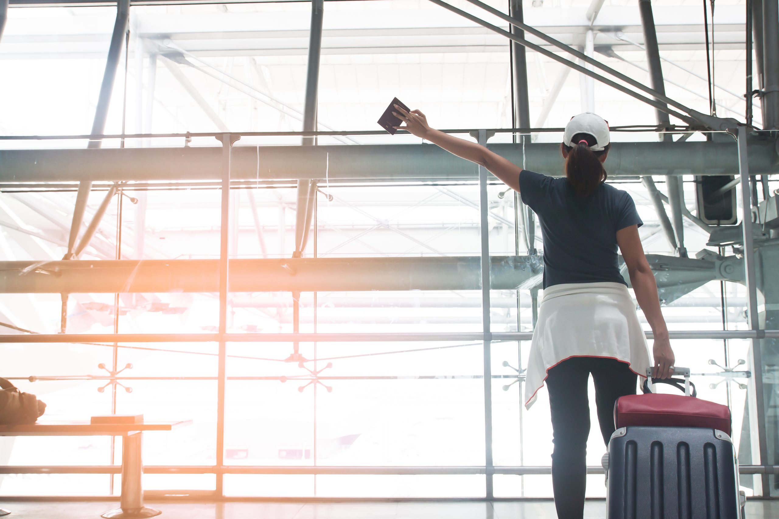 Woman with passport and suitcase