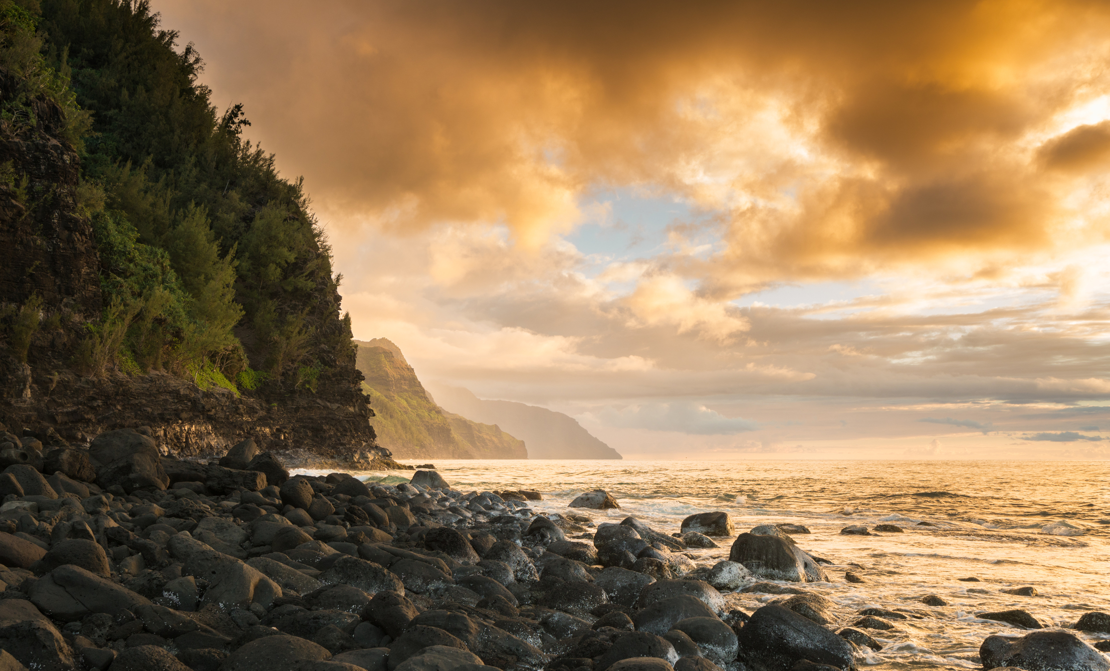 Sun setting over the receding headlands of the Na Pali coast from Ke`e Beach