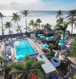 Outdoor pool of a resort next to the sandy ocean beach