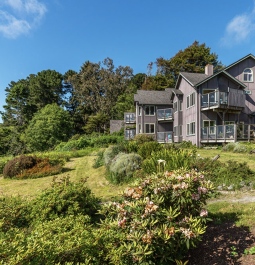 bed and breakfast on a grassy lawn overlooking the ocean