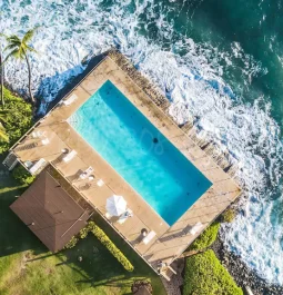 Pool at rental home that juts out into the ocean