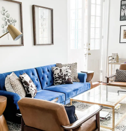 living room with blue couch and iron-accented decor