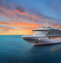 Luxury cruise ship sailing to port on sunrise