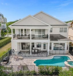 Aerial view of a two-story villa with a swimming pool